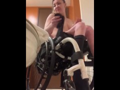 Disabled girl undressing in wheelchair