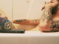 Tattooed bearded daddy bear in the tub for a soak