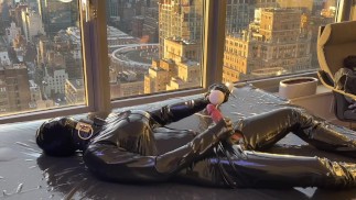 Latex bimbo plays with her cock