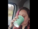 girlfriend drinks a big cup of very yellow piss in car.