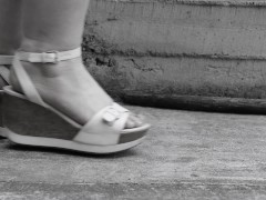 Women's feet in sandals on a high platform,