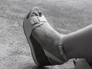 Women's Feet in Sandals on a High Platform,