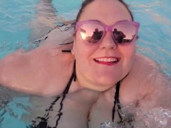BBW bouncing in the pool in a string bikini