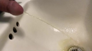 Slow mo pissing in the sink