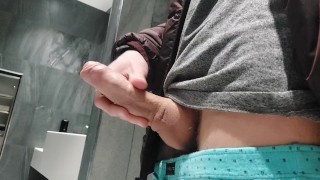 Horny teen bisexual boy stroking his dick and shooting a lot of cum in public male restroom