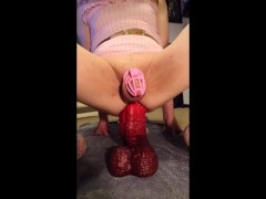 Sissy in chastity playing with new large dildo