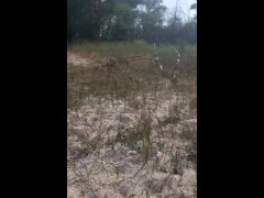naked exhibitionist sunbathing on a public beach