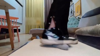 Japanese devil girl gives a guy a footjob and handjob