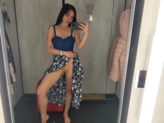 Busty  hot brunette is trying dresses in the store