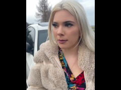 A nice blondie in colorfull dress is smoking and spitting