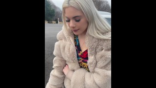 A nice blondie in colorfull dress is smoking and spitting