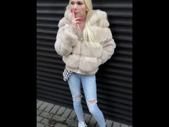 A blondie teen is smokig and hocking and spitting loogies making a smily spit puddle