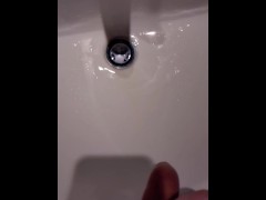 Hoping not to get caught while peeing in the bathroom sink.