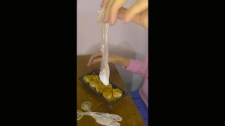 Sissy femboy empties the used condoms into her meal before adding her own dose of cum. And eat.