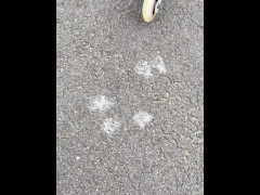 A rollerblade blondie girl is littering and smoking and spitting loogies while smoking a cigarillo