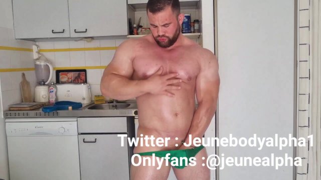 bodybuilder with oiled body jerks off and flexes