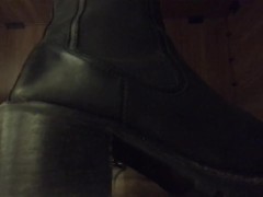 Candid my feet in black boots under my desk in the office