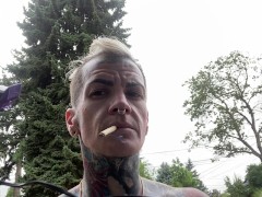 Butch dyke smokes and shaves head flexes muscles
