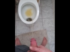 Big and hard cock of a young guy gives out a golden shower in the morning