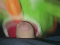 I'm playing with Yoshi the dinosaur in the barn