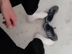 a young skater shows off his white socks and sneakers