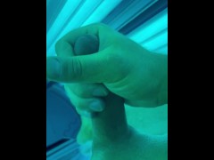 Tug job in public tanning bed with huge cum fountain