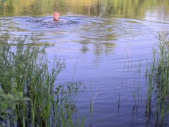 Swimming in lake in clothes. Black Wet skirt, wet stockings and tank top. Wetlook transgirl in lake.