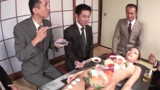 More men eat food from a Japanese girl and stick toys inside her hairy pussy