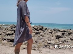 Hot mom in transparent t-shirt on the beach at low tide