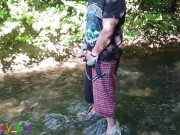 Preview 1 of German guy stands in a creek, pisses and jerks off his hard cock