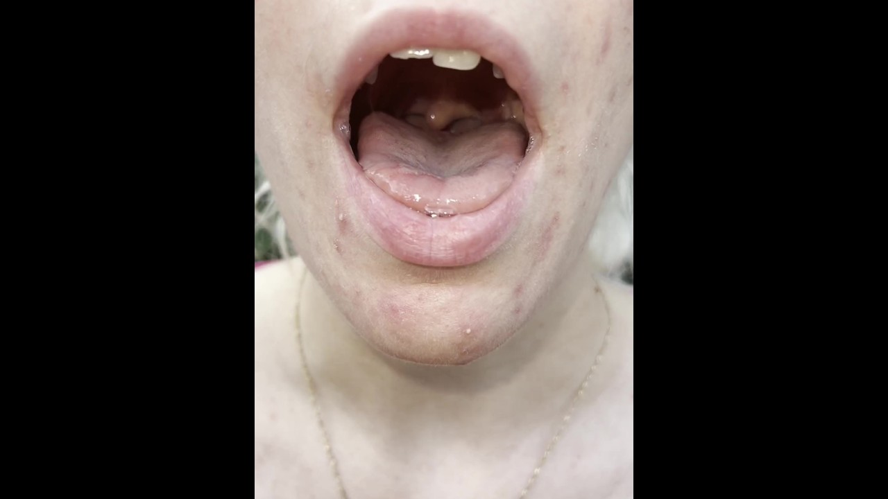 A nice blondie is coughing and spitting close up