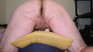 Close up of man ass while riding his sleeve while using pillows for better support and feel