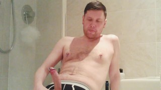 Dude with pierced nipples and cock jerks off his uncut dick.