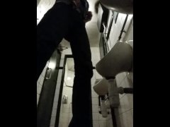 Pissing in a public urinal
