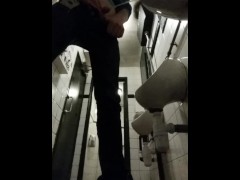 Pissing in a public urinal