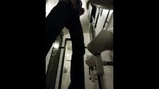 Pissing in a public urinal