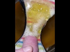 Pissing onto panties in a bowl in slow motion