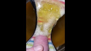 Pissing onto panties in a bowl in slow motion