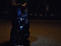 Milf whore gives a blowjob on a leash in a public place