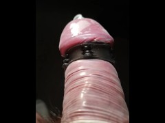 Close up POV of vibrating penis in slow motion while wearing condom