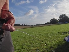 Pissing on a camp field in the morning
