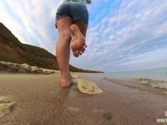 Barefoot Girl Walks Over The Summer Seashore