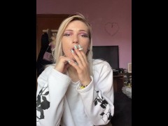 sexy blonde high school girl smokes a cigarette