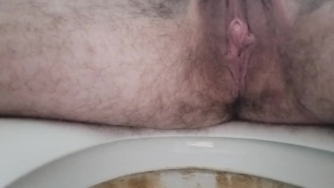 Sitting on the toilet the other way pissing