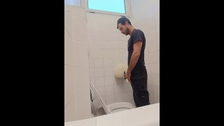 camera in de badkamer van een bekend bedrijf, man pist met zijn Italiaanse lul