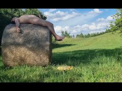 A chub cums outside after playing with a thong on a hay bale