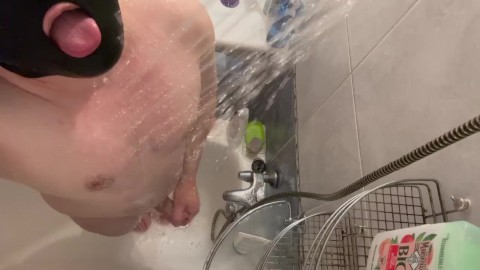 A hairy man takes a shower and jerks off his big humped cock