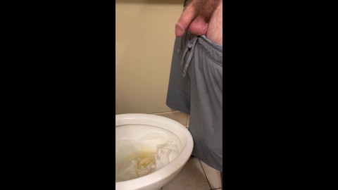 Sexy tattooed DILF peeing in a public bathroom