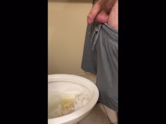 Sexy tattooed DILF peeing in a public bathroom