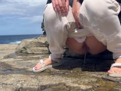 girl pissing on excursions on the rocks